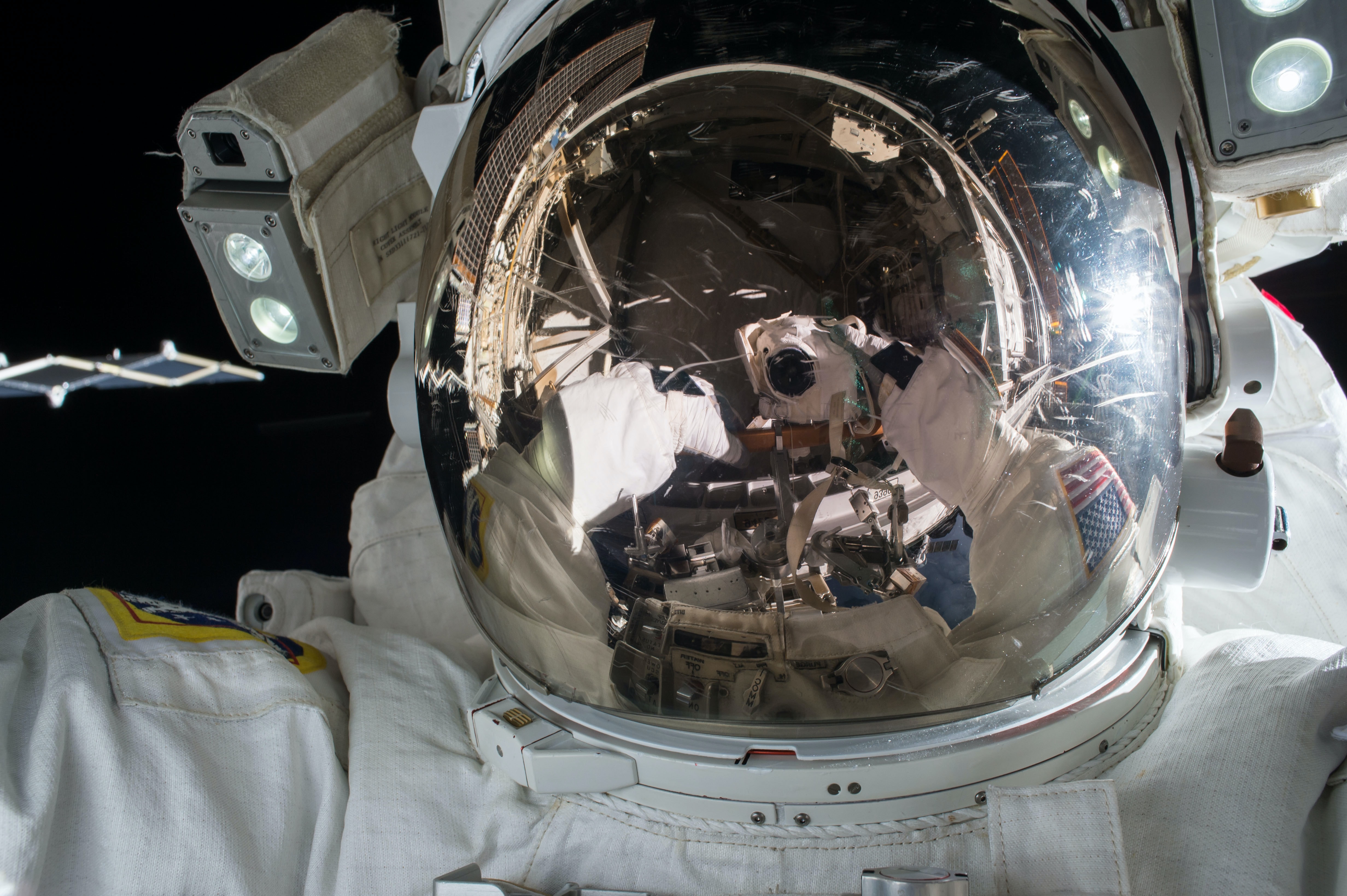A close-up of an astronaut's helmet in space